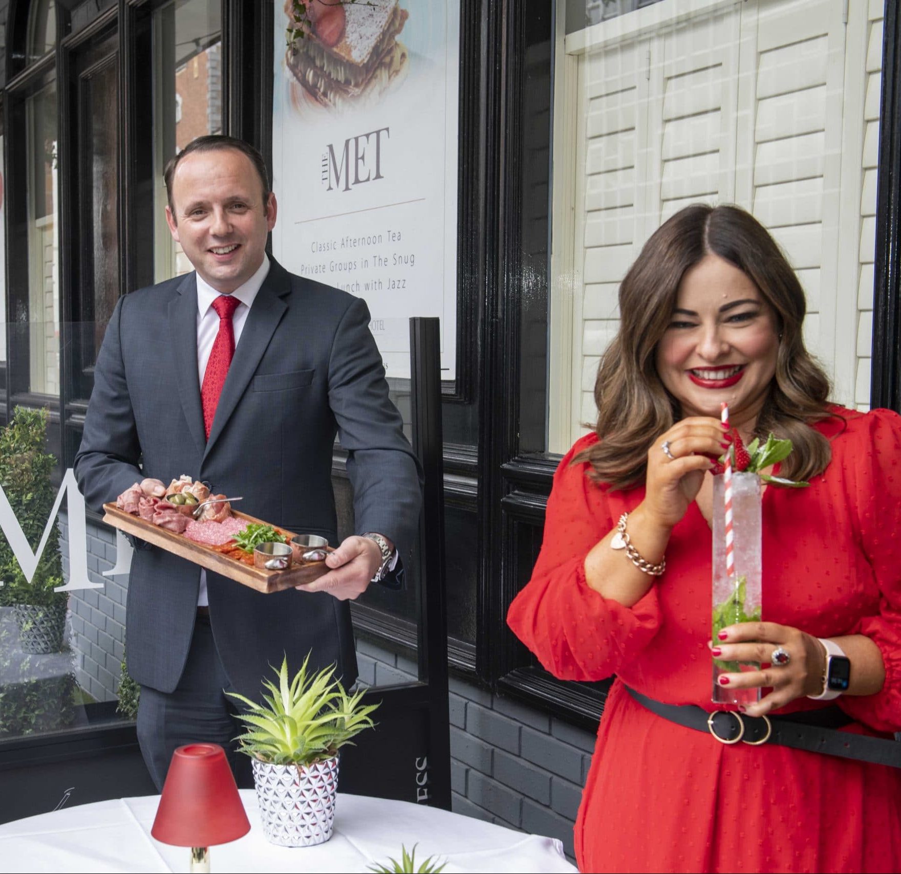 The Metropole managers showing prosecco cocktails on their outdoor terrace